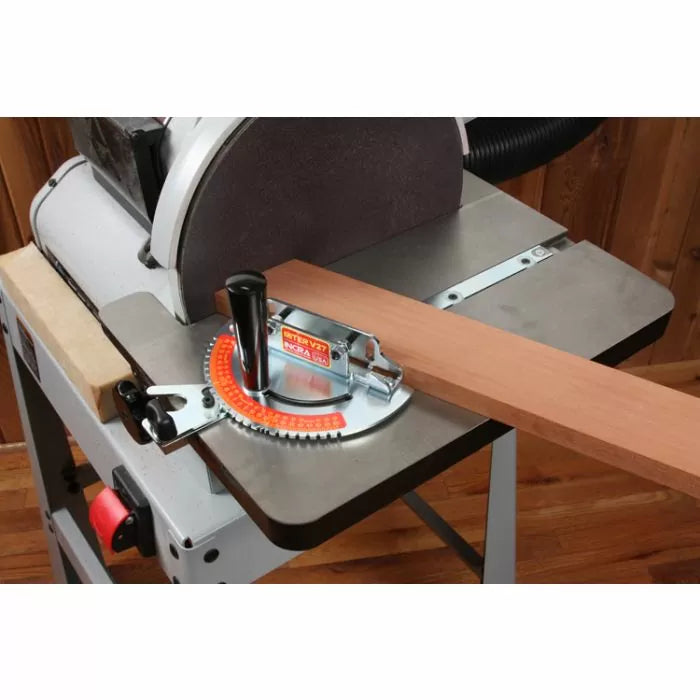 Tabletop disc sander with miter gauge and wooden board on metal work surface for woodworking