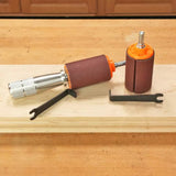 Drum sander kit with sanding drums and wrenches on a wooden workbench