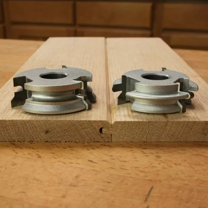 Tongue and groove router bit set on wood boards for woodworking joinery