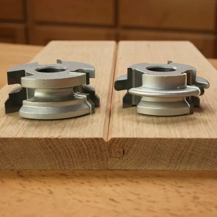Tongue and groove router bit set on hardwood board for woodworking joints
