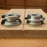 Tongue and groove router bit set on hardwood board for woodworking joints
