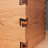 Close-up of decorative dovetail box joint in contrasting hardwood for woodworking projects