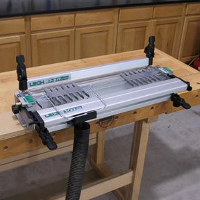 Leigh D4R Pro dovetail jig for woodworking mounted on a workbench in a workshop