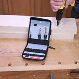 Woodworker using drill and countersink bit set on workbench with wood blocks