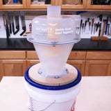 Quick-Snap dust separator for woodworking mounted on a bucket in a workshop setting