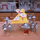 Woodworking router bits and a yellow gauge tool displayed on a workbench in a workshop.