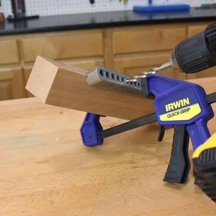Drill and pocket hole jig clamped to wood for precise woodworking joinery