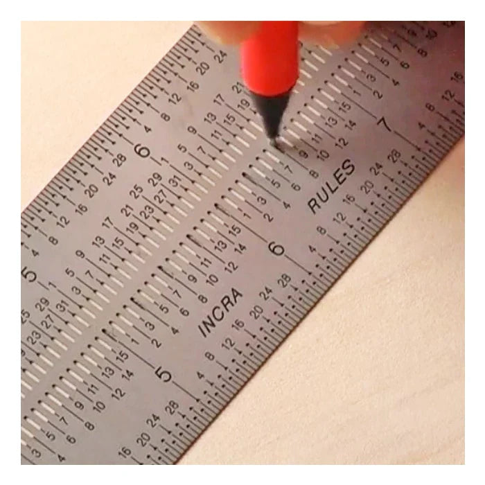 Precision stainless steel ruler for woodworking with engraved measurements and red pencil marking