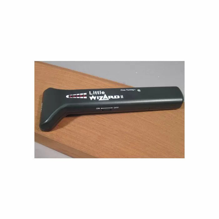 Little Wizard II metal detector for woodworking placed on a wooden board