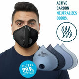 Man wearing black active carbon respirator mask with replaceable filters for woodworking dust protection.