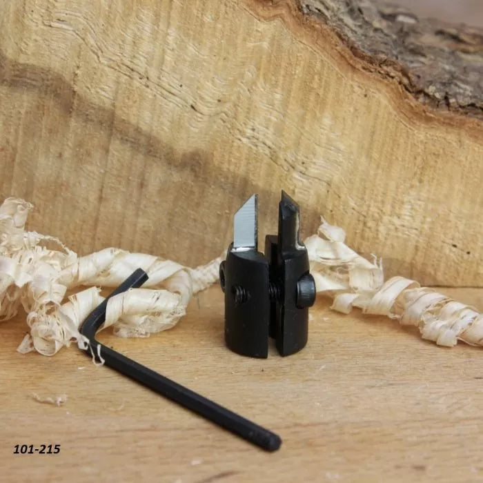 Woodworking plane blade cutter with adjustment tool, set on wood shavings