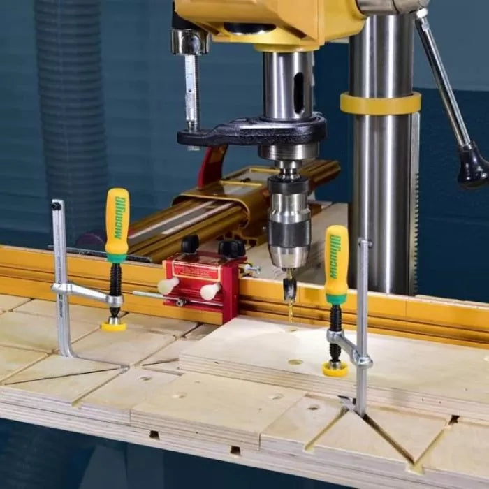 Drill press with MatchFit jig system, clamps, and wood panels in woodworking setup