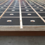 MFT workbench top with grid pattern, dog holes, and textured black surface for woodworking