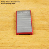 Wedge-shaped sharpening stone with red border on wood surface, labeled 800 grit