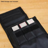Set of sharpening stones in a fitted storage case on a wooden workbench