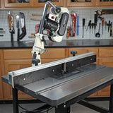 Woodworking router table setup with lift system and fence in workshop setting