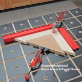 Woodworking jig set with red fences and toggle clamps securing boards on a workbench