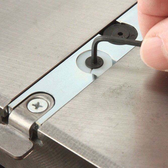 Allen wrench adjusting miter gauge bar on metal woodworking tool surface