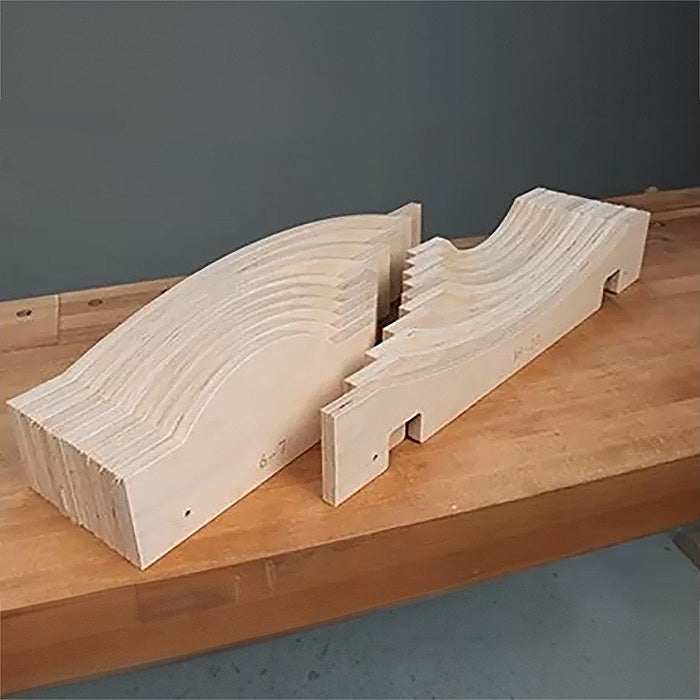 Set of nested woodworking templates for curved cutting, displayed on a workbench