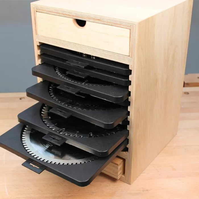 Wooden saw blade storage box with pull-out trays holding circular saw blades