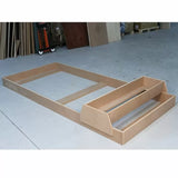 Unfinished MDF workbench base and shelves on workshop floor for woodworking projects