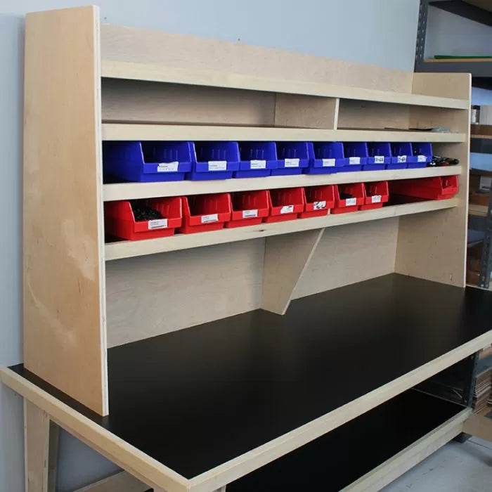 Woodworking workbench with shelves and organized storage bins for shop tools and parts