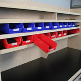 Workshop storage bins system with blue and red plastic parts bins on a wooden shelf