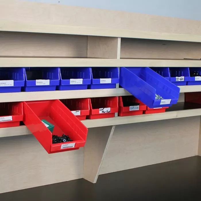 Woodworking shop storage rack with labeled blue and red plastic bins holding fasteners