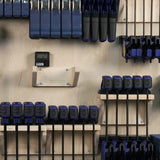 Woodworking clamps organized on a wall-mounted rack in a workshop setting