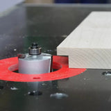 Router table with rabbeting bit cutting a rabbet joint in a wooden board