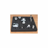 Foam tray organizer holding various woodworking router bits on a wooden surface