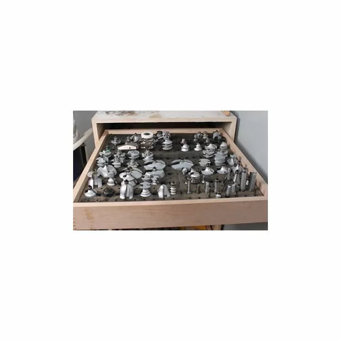 Open drawer with organized woodworking router bits and cutters for precision tool storage