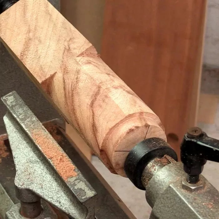 Rough wood blank mounted on lathe for woodturning in workshop setting