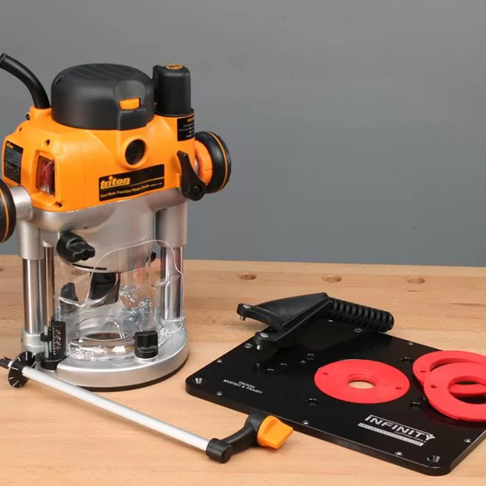 Woodworking router tool with router table plate and accessories on workbench