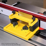 Yellow featherboard mounted on router table fence for woodworking precision and safety.