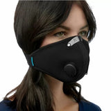 Woman wearing black mesh dust mask with breathing valve and adjustable nose clip, closeup