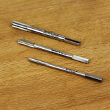 Set of three metal threading taps for woodworking or metalworking on a wood surface