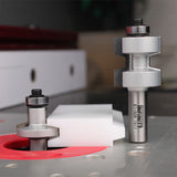 Router table with two stacked router bits and precision-cut wood workpiece