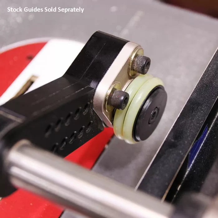 Close-up of a router table fence with stock guide attachment and adjustment bolts