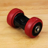 Double roller woodworking tool with red wheels on a wood surface