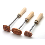 Set of three wood branding irons with wooden handles and engraved brass heads