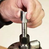 Hand installing straight router bit into router collet for woodworking tool setup