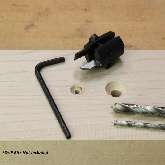 Woodworking adjustable hole cutter with hex key and two drill bits on a wooden board
