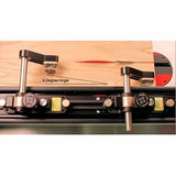 Table saw featherboard jig set at 5 degree angle with wood piece on saw top