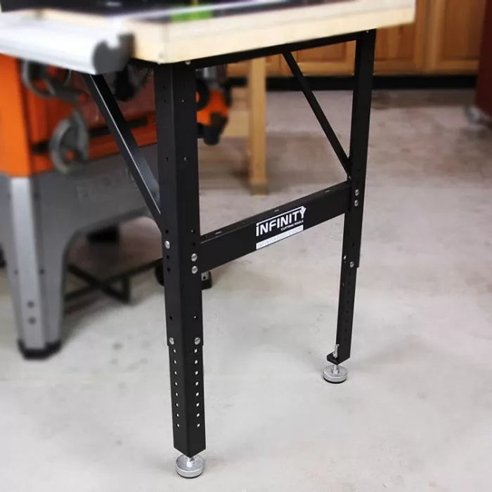Adjustable steel router table leg set with leveling feet in a workshop setting