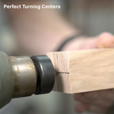 Wood lathe turning tool aligning square wood block for precise woodworking project