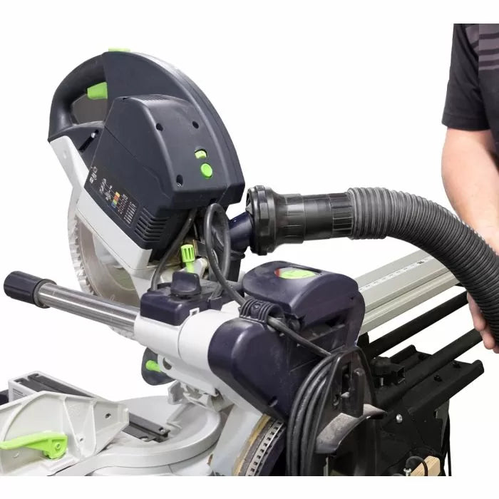 Dust collection vacuum hose attached to sliding miter saw in woodworking setup