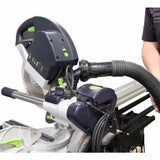 Dust collection vacuum hose attached to sliding miter saw in woodworking setup