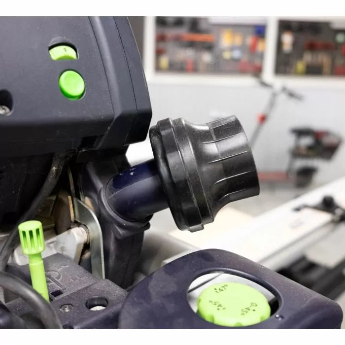 Close-up of a woodworking tool dust extraction port with control knobs in a workshop setting