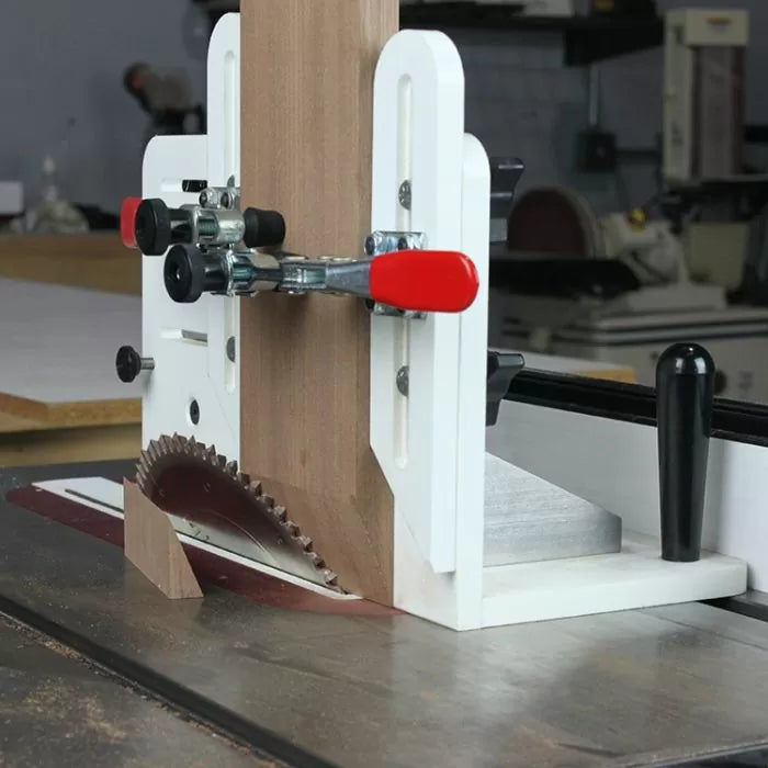 Table saw tenoning jig cutting wood with vertical and horizontal clamps in woodworking shop